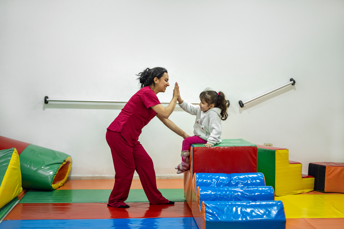 Girl doing occupational therapy exercises.